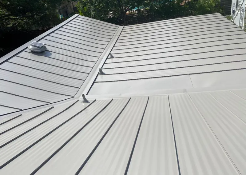 Solar attic fan installed on a metal roof for Roof Ventilation in Meraux